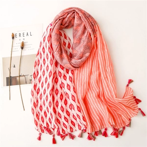Close-up of floral print cotton scarf with geometric patterns and tassel details