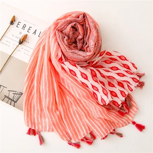 Detailed view of coral pink ethnic geometric floral print scarf with soft fringe edges