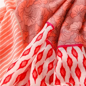 Close-up of vintage floral and geometric patterns on soft breathable cotton scarf fabric