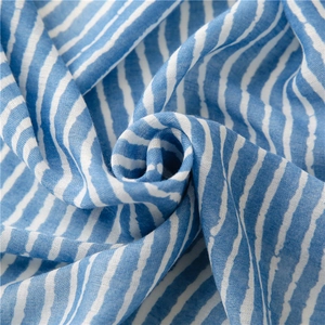 Detail of blue and white striped cotton-linen scarf with soft breathable texture