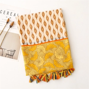 Detailed shot of ethnic floral pattern scarf with colorful fringes and geometric texture
