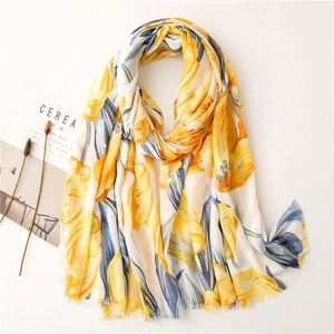 Detail of floral print scarf with natural raw edges and light blue leaf pattern