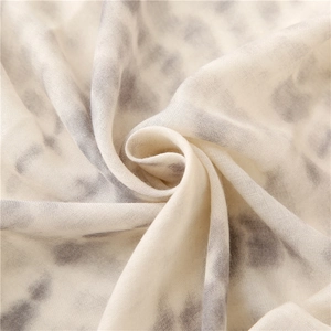 Macro shot of breathable leopard print scarf fabric showing light linen texture
