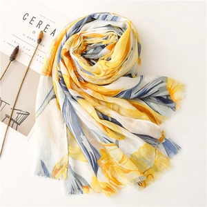 Detailed texture of lightweight cotton-linen floral scarf with frayed edges and soft print