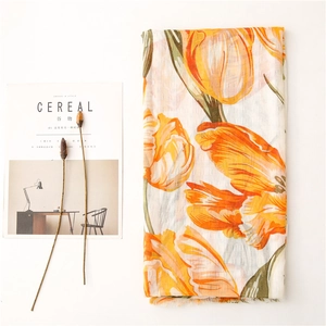 Detail of floral tulip print on lightweight cotton-linen shawl with textured raw edges