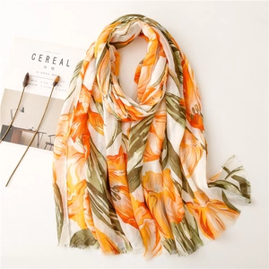 Floral print cotton linen feel scarf with orange and white patterns and frayed edges