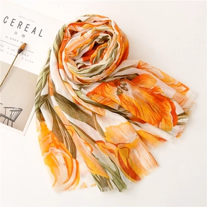 Detail of vibrant floral print cotton linen shawl with delicate tassel edge decor
