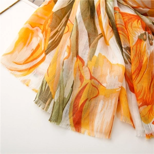 Close-up of vibrant tulip print on lightweight cotton linen fabric with frayed fringe edges
