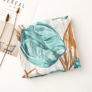 Detail view of cotton-linen feel scarf with blue floral prints and striped fabric texture