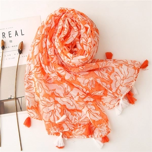 Orange floral print shawl with decorative tassels and a soft cotton-linen feel