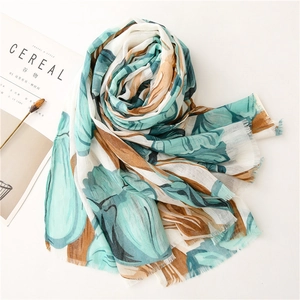 Detail of floral print scarf with soft cotton-linen texture and fringe edges