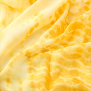 Detailed view of yellow tie-dye linen texture on a soft lightweight fashion scarf