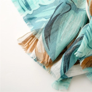 Close-up of lightweight cotton-linen floral scarf showing texture and fringe details