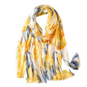 Lightweight yellow tulip floral cotton shawl with fringed edges on a white background