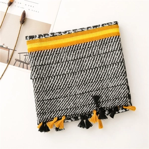 Detail of cotton scarf featuring leopard print, stripes and bright yellow fringes