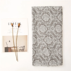 Detail of vintage Damascus floral print scarf with soft fringe edges on white background