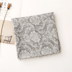 Detail of vintage floral print scarf with soft fringe edges and linen texture finish