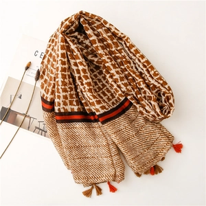 Macro detail of geometric checkered scarf with elegant fringes and striped patterns