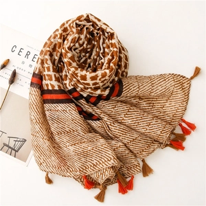 Detail of vintage geometric scarf with leopard print and ethnic tassel hem style