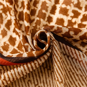 Close-up of geometric mesh scarf with vintage brown giraffe patterns and soft fabric texture