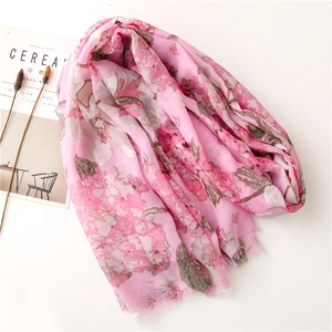Floral print pink long scarf with tassels and vintage ethnic style patterns on white background