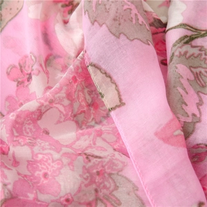Detail of pink floral cotton-linen scarf showing high-quality stitching and texture