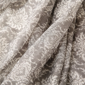 Macro shot of grey and white paisley floral patterns on soft cotton-linen fabric texture