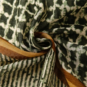 Detailed texture of retro geometric pattern scarf with dark green and gold trim