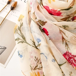 Detail of floral chiffon scarf with silver metallic threads and shimmering sequins
