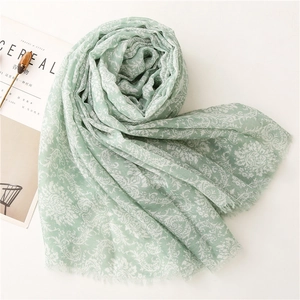 Light green long scarf with white vintage damask floral pattern and fringed edges