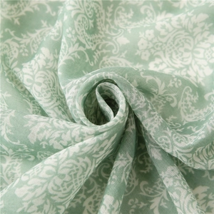 Close-up of light green floral scarf showing soft fabric texture and paisley pattern