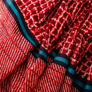 Close-up of red and blue geometric grid patterns on lightweight vintage style scarf