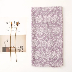 Detail of purple scarf with white damascus pattern and raw fringe edges on Cereal magazine