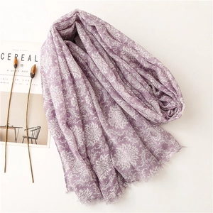 Detail of light purple floral print scarf with soft fringe edges and damascus patterns