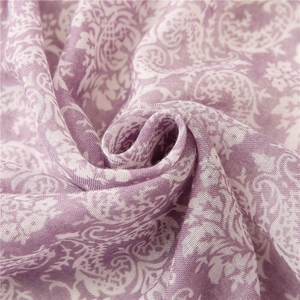 Detailed close-up of lilac paisley floral print on breathable lightweight fabric scarf