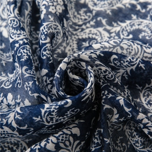 Close-up of navy blue and white paisley print fabric with soft cotton linen texture