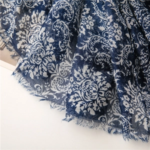 Detail of dark blue paisley print shawl with soft cotton-linen texture and frayed edges