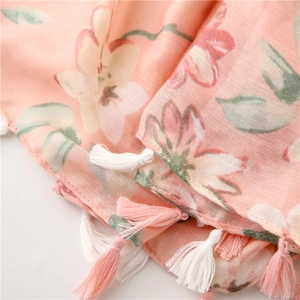 Primo piano dell'itinerario rosa chiaro con stampe floreali e nappe con frange