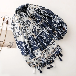 Detailed view of vintage blue porcelain print scarf with handcrafted tassels on edges