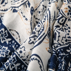 Close-up of vintage blue and white porcelain floral pattern on breathable linen feel fabric