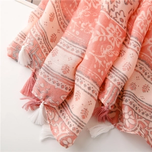 Macro shot of pink and white fringe details on a vintage floral cotton linen scarf