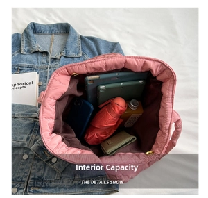 Macro view of large interior capacity for pink quilted tote bag holding daily essentials