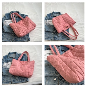 Detail view of pink quilted puffer tote bag with spacious interior and soft nylon texture