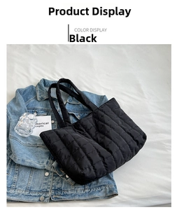 Detail view of black quilted nylon shoulder bag with checkered texture and double handles