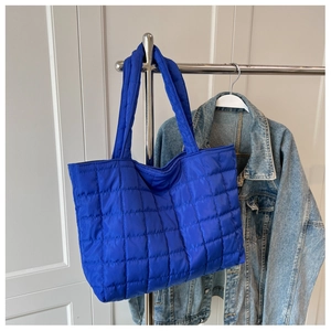 Detail view of Klein blue quilted tote bag made of lightweight nylon with checkered pattern