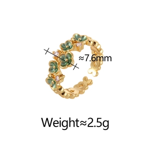 Detailed view of green enamel flower ring with pink zircons and gold finish