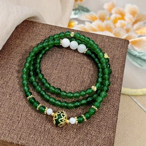 Three-layer green chalcedony beaded bracelet with a hollow gold pendant in vintage style
