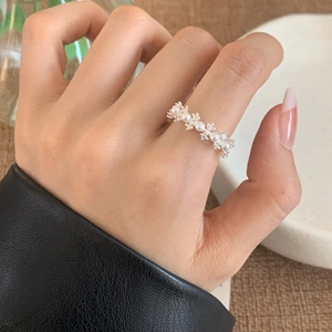 Elegant French style silver pearl ring with sparkling zircon accents on finger