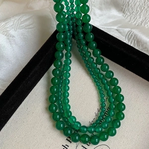 Close-up of elegant multi-layered green chalcedony beaded necklace with smooth finish