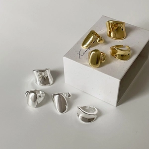 Minimalist gold and silver rings in irregular organic shapes with polished finish